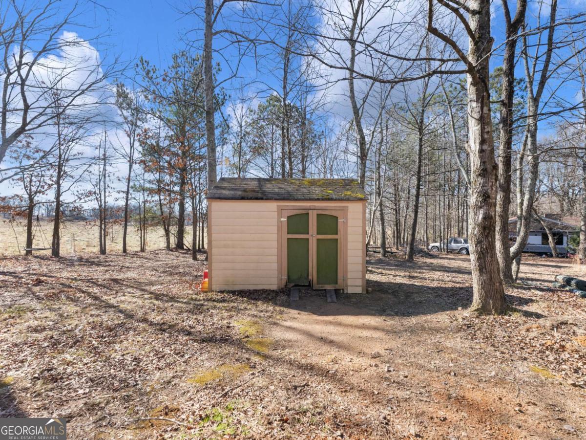 5539 McEver Road Flowery Branch, GA 30542 - Photo 9 of 41 a view of a house with a snow in the yard