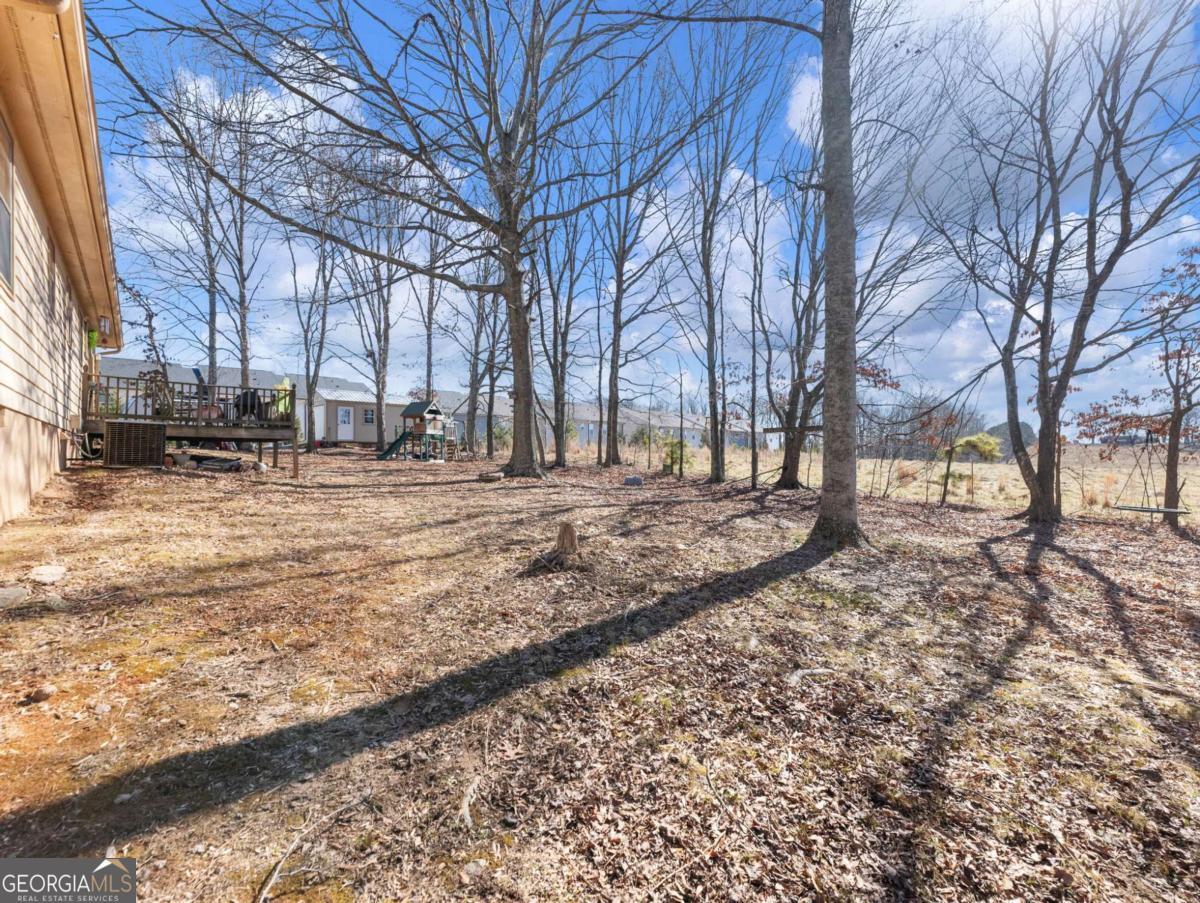 5539 McEver Road Flowery Branch, GA 30542 - Photo 10 of 41 a view of a yard covered with snow