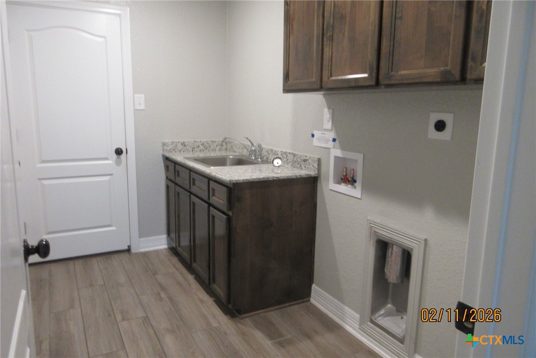 7623 Palladium Loop Killeen, TX 76542 - Photo 23 of 40 a utility room with wooden floor washer and dryer