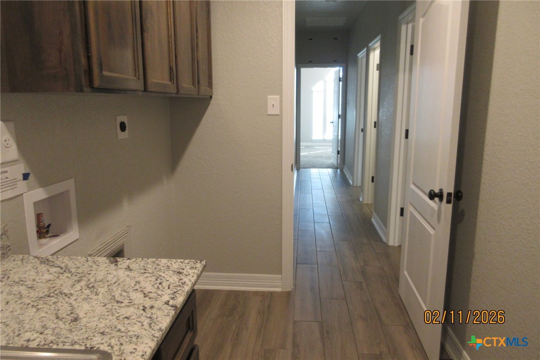 7623 Palladium Loop Killeen, TX 76542 - Photo 24 of 40 a view of a hallway with wooden floor and cabinet