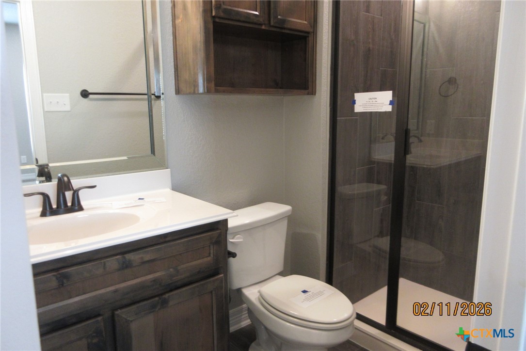 7623 Palladium Loop Killeen, TX 76542 - Photo 39 of 40 a bathroom with a sink a toilet and shower
