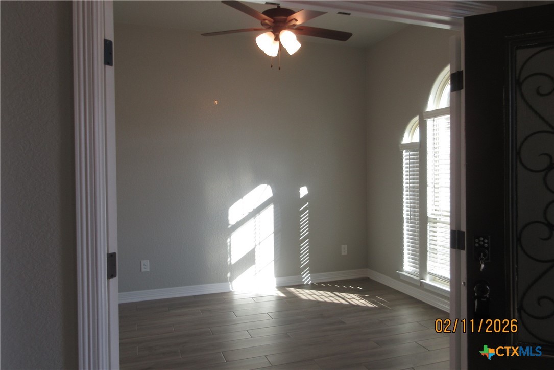 7623 Palladium Loop Killeen, TX 76542 - Photo 5 of 40 a view of an empty room with wooden floor and a window