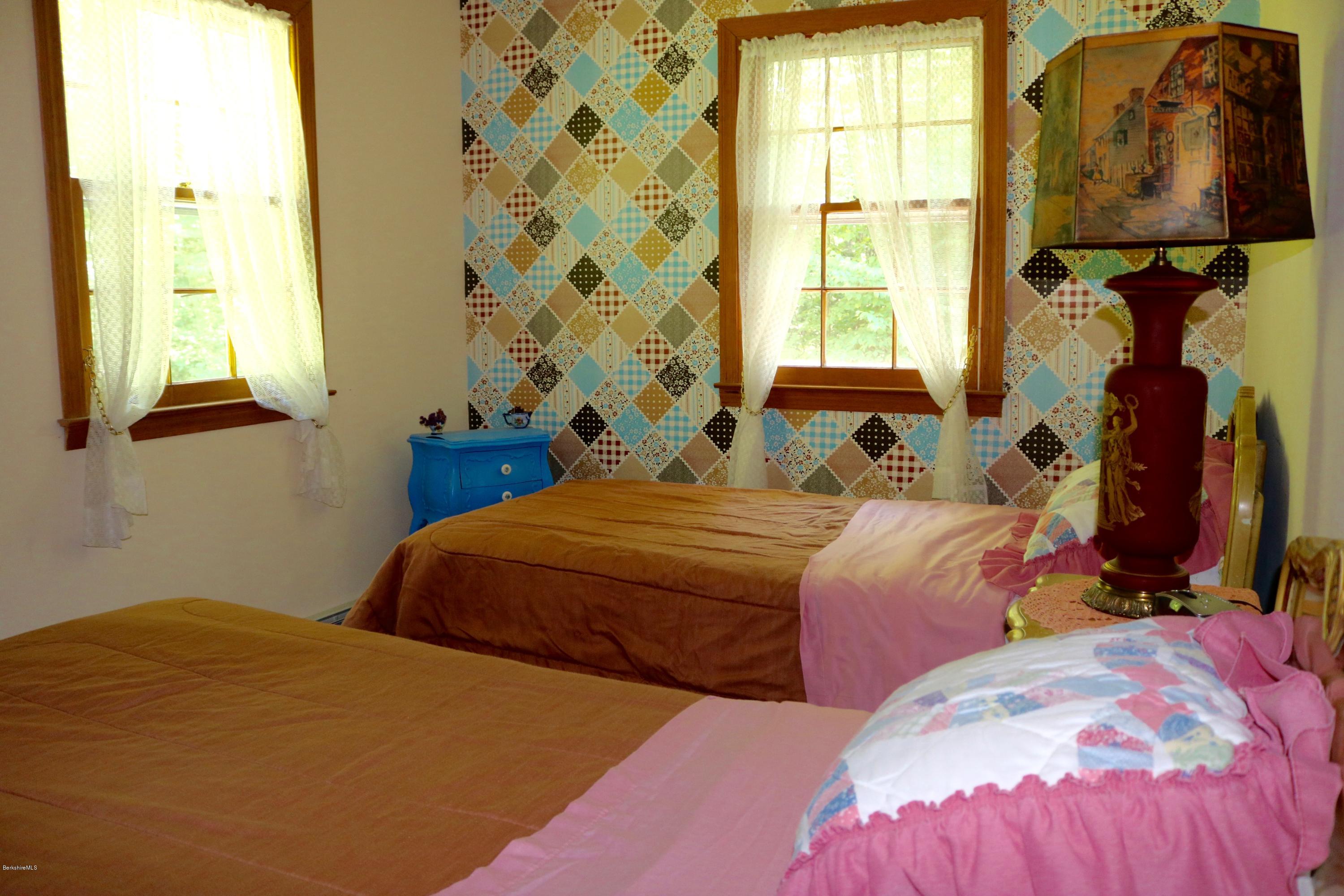 2401 West Center Road Otis, MA 01253 - Photo 14 of 24 a bedroom with two beds and a window