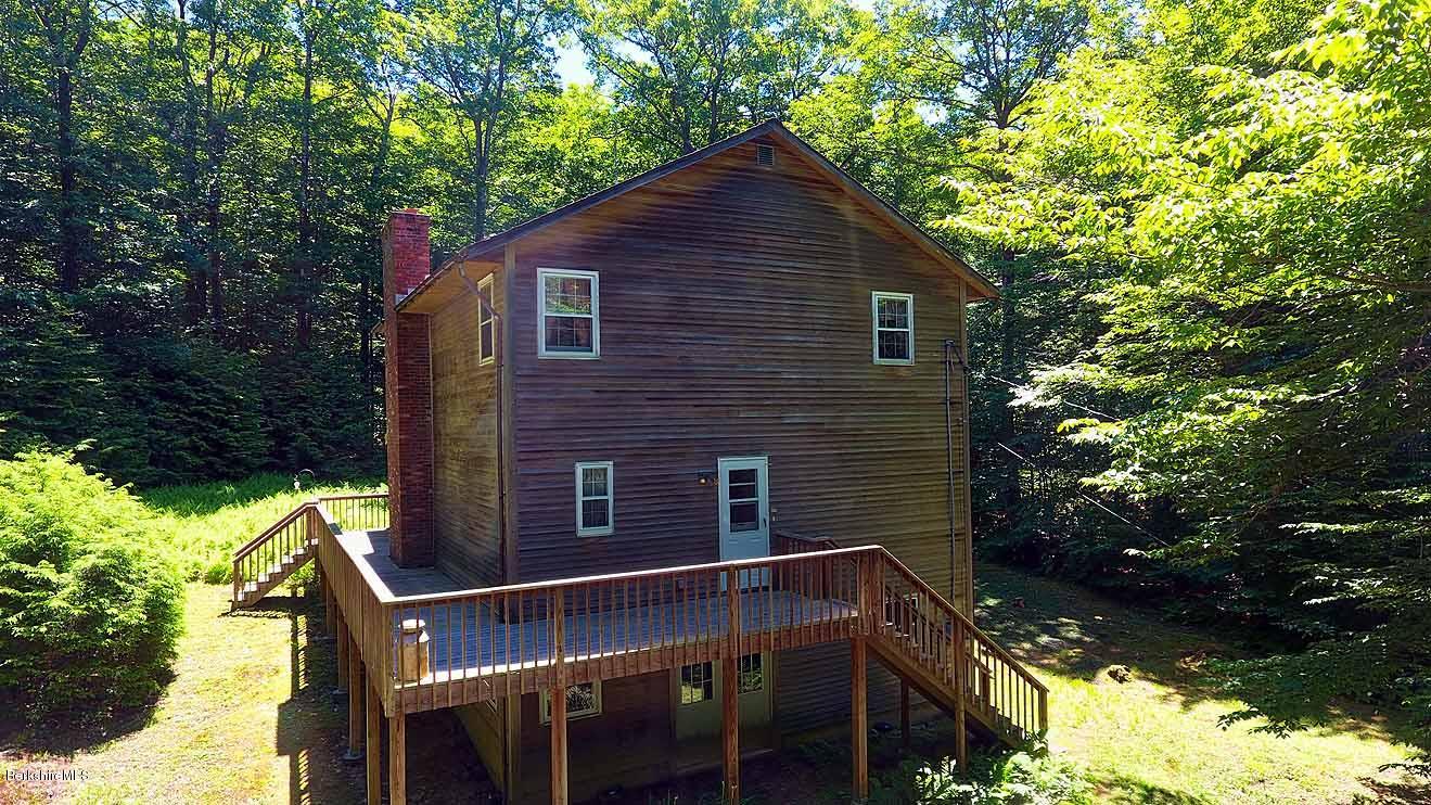 2401 West Center Road Otis, MA 01253 - Photo 20 of 24 a backyard of a house with yard table and chairs