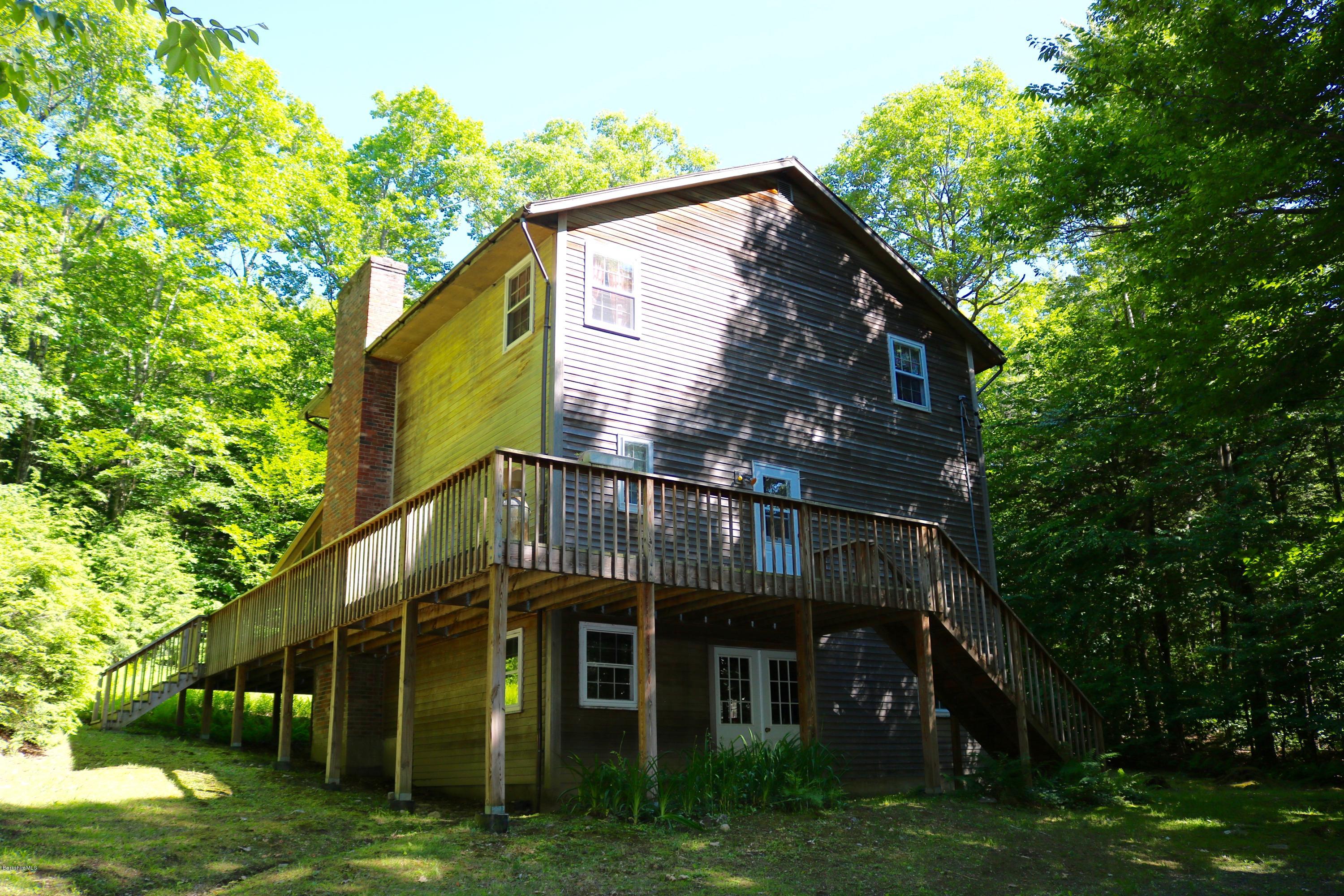2401 West Center Road Otis, MA 01253 - Photo 3 of 24 a view of a big house with a big yard plants and large trees