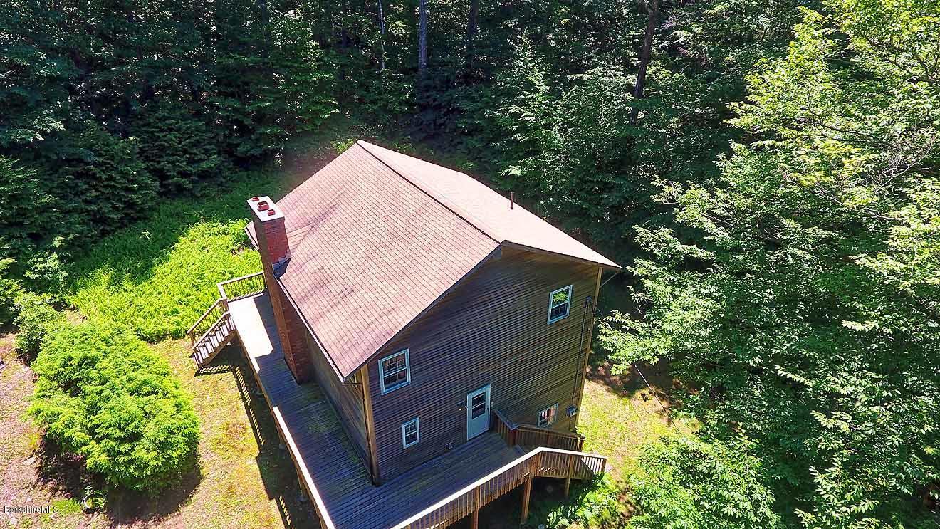 2401 West Center Road Otis, MA 01253 - Photo 22 of 24 a backyard of a house with lots of green space