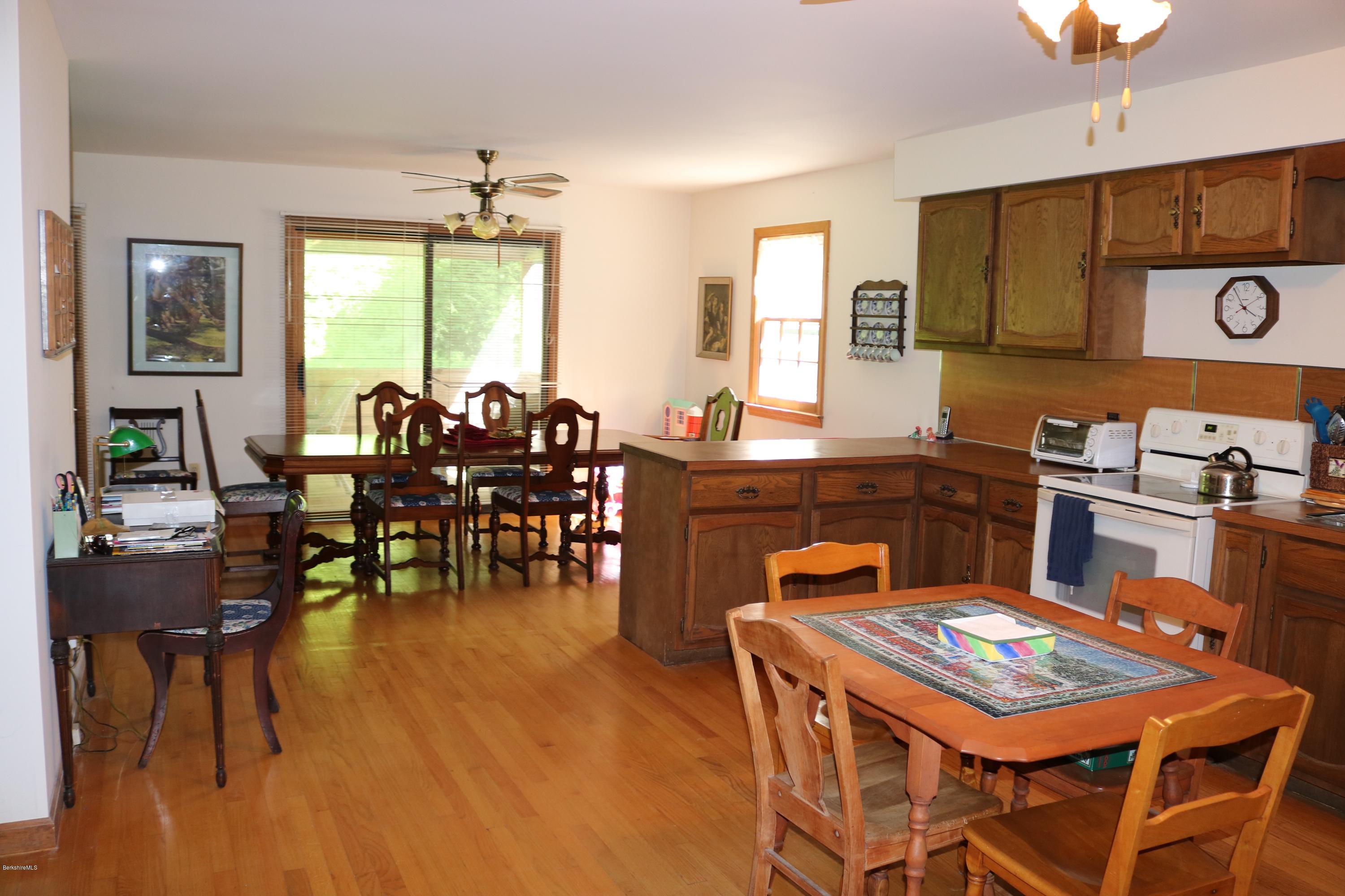 2401 West Center Road Otis, MA 01253 - Photo 5 of 24 a dining room with chairs and wooden floor