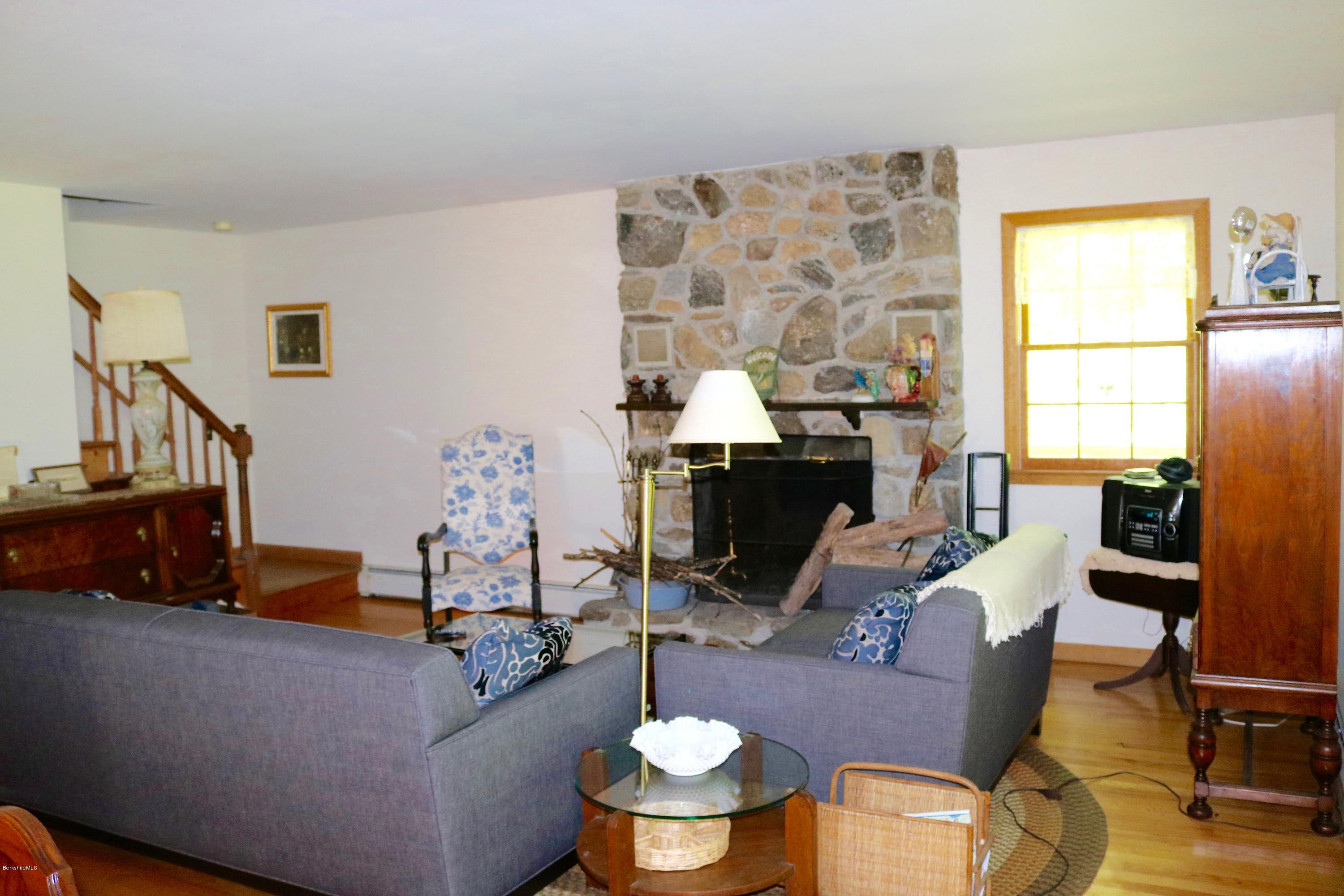 2401 West Center Road Otis, MA 01253 - Photo 6 of 24 a living room with furniture and a fireplace