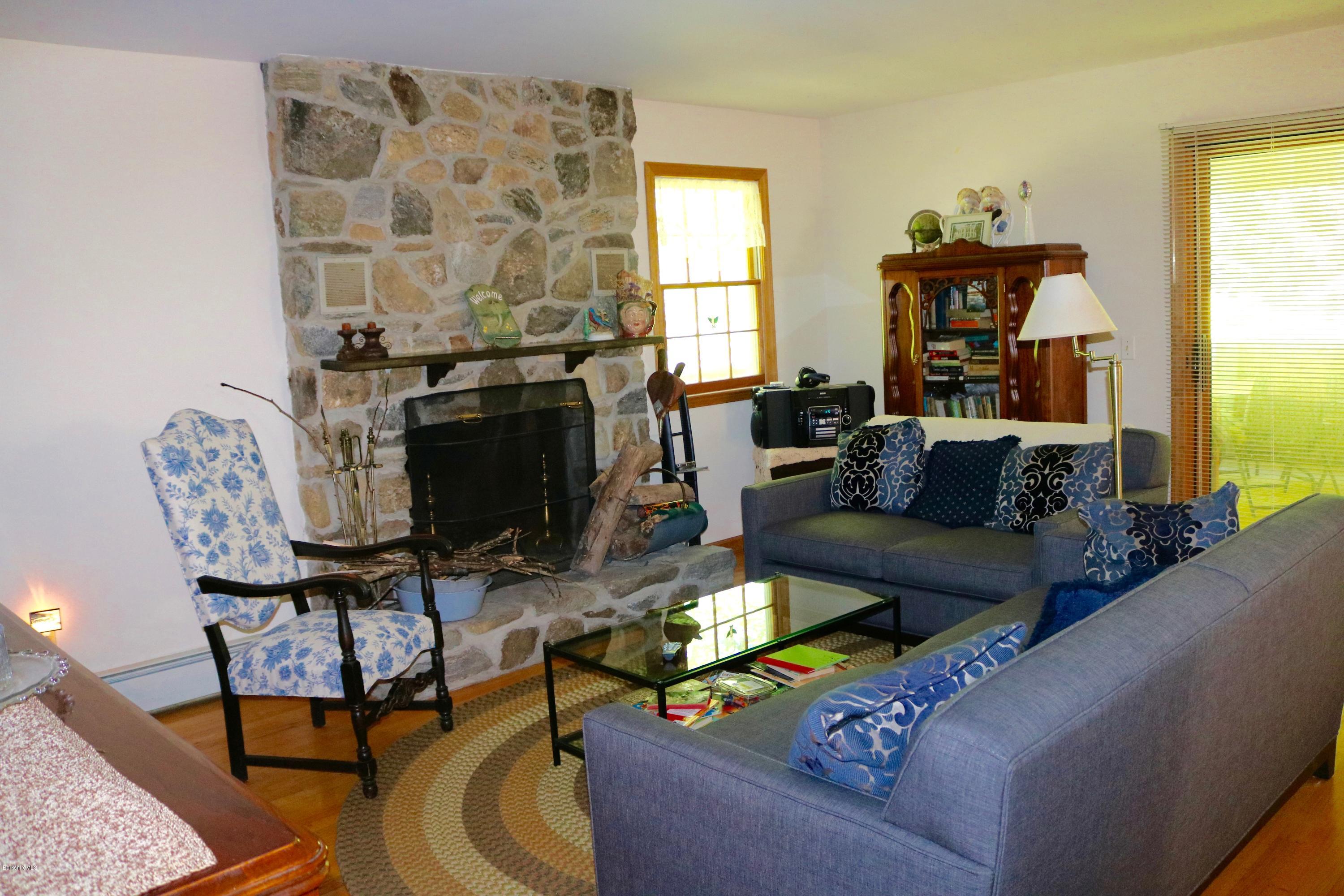 2401 West Center Road Otis, MA 01253 - Photo 7 of 24 a living room with furniture and a fireplace