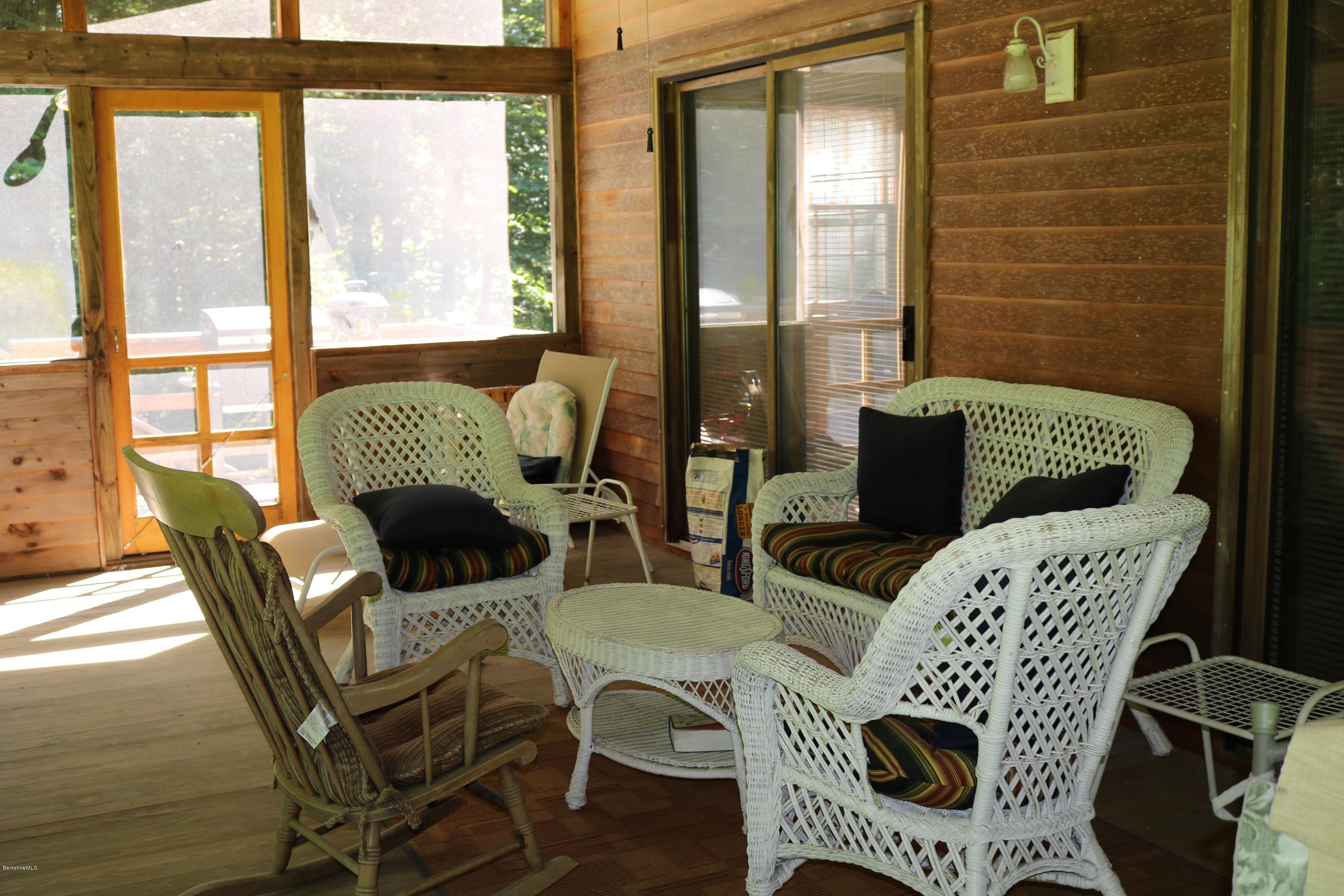 2401 West Center Road Otis, MA 01253 - Photo 10 of 24 a view of a dining room with furniture large windows and wooden floor