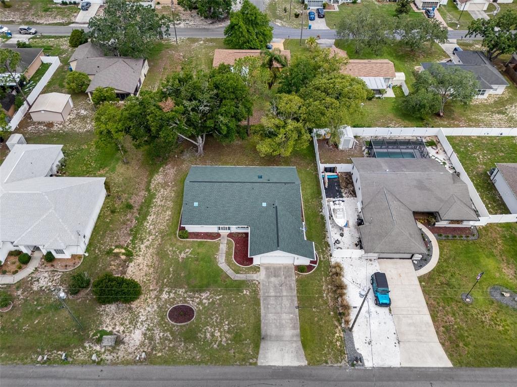 5035 Harbinger Road Spring Hill, FL 34608 - Photo 2 of 47 an aerial view of a house with yard swimming pool and outdoor seating