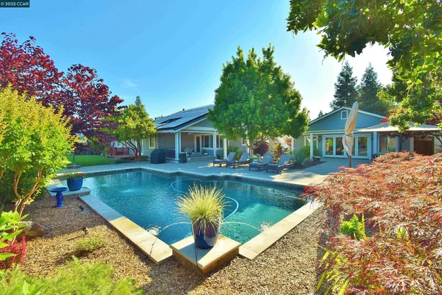 a front view of a house with a garden