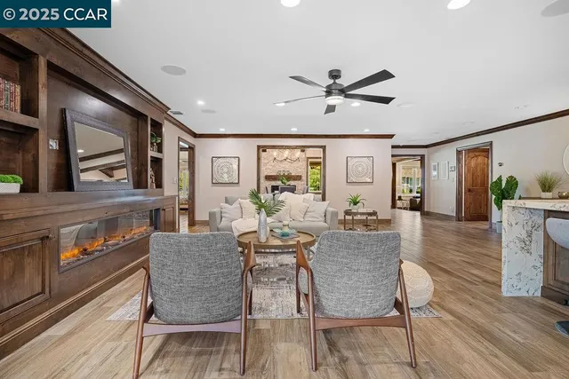 a kitchen with stainless steel appliances granite countertop a lot of cabinets and wooden floor