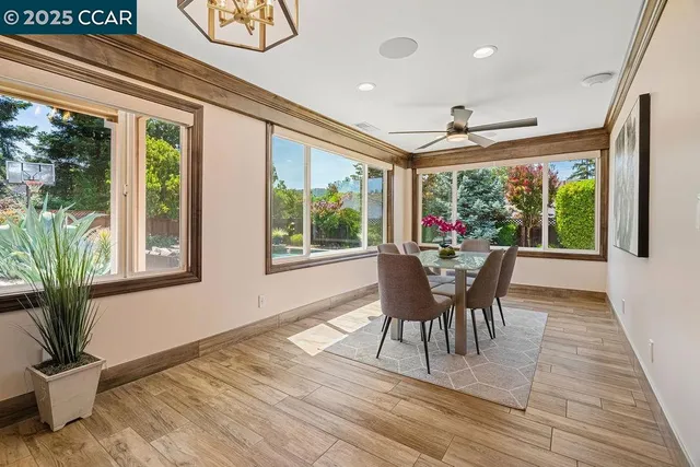 a view of a hallway with wooden floor and entryway