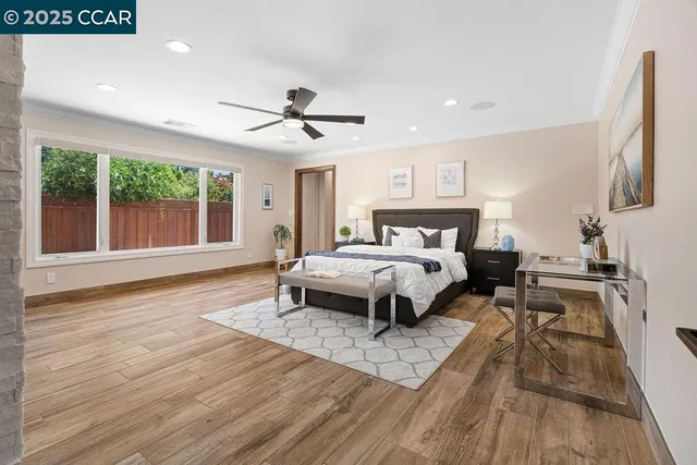 a bedroom with a bed and a view of kitchen