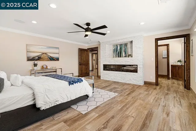 a bedroom with a bed and a flat tv screen on dresser
