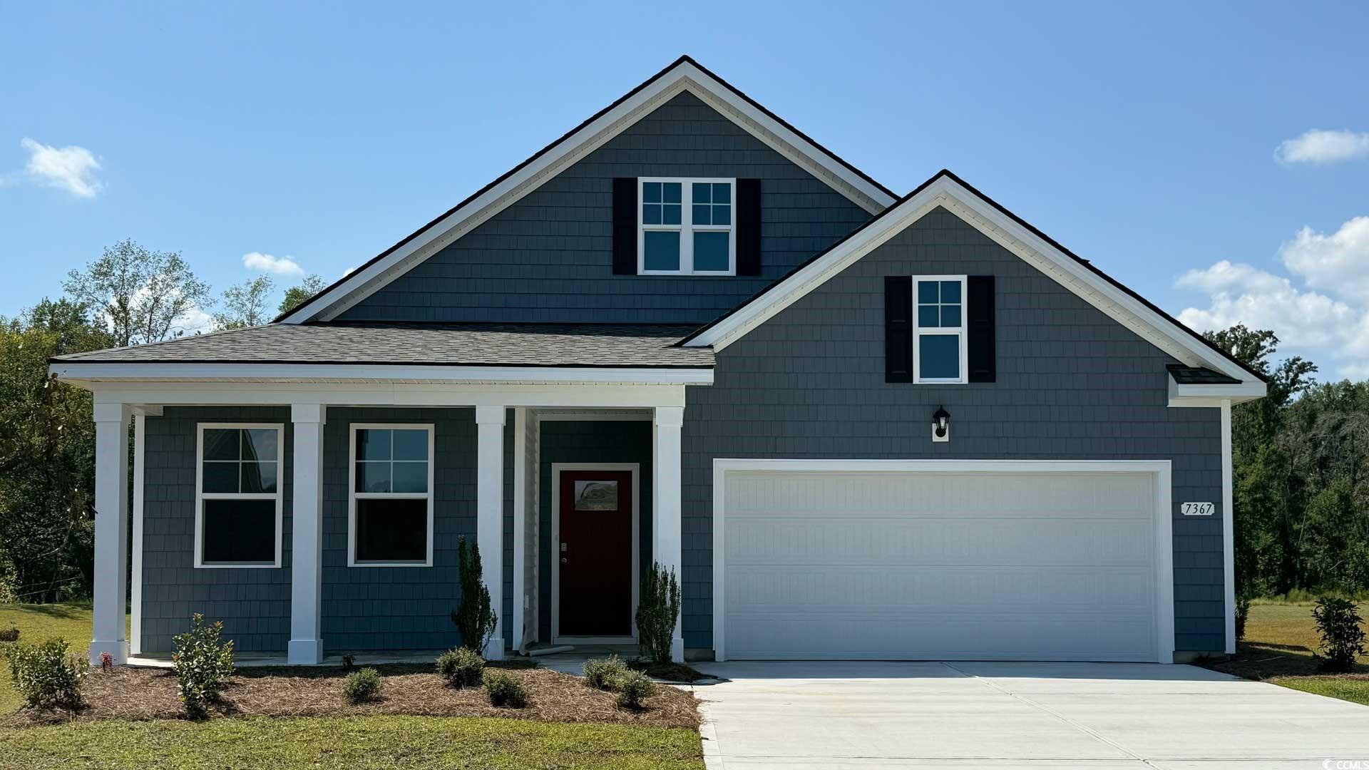 7367 Meadow Walk Loop Loris, SC 29569 - Photo 1 of 25 View of front facade featuring concrete driveway, a porch, a garage, and a shingled roof