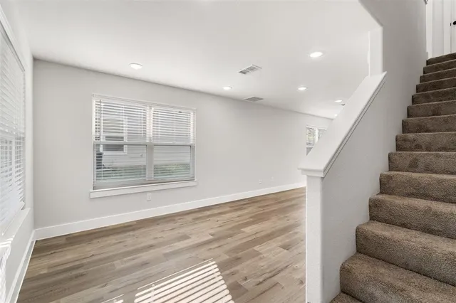 a view of livingroom with furniture staircase and windows