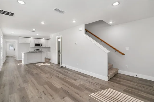 a view of kitchen with wooden floor and electronic appliances