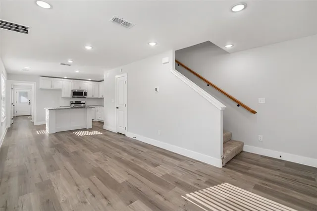 a view of kitchen with wooden floor and electronic appliances