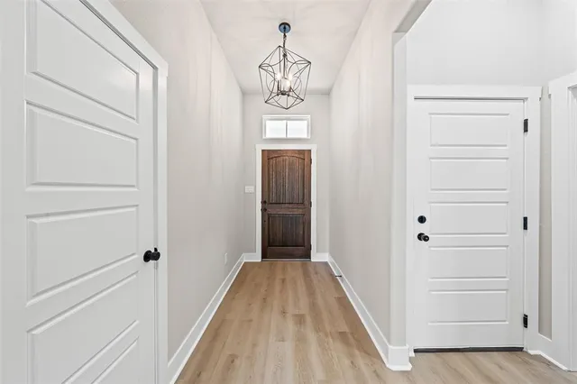 a view of a hallway view with wooden floor and staircase