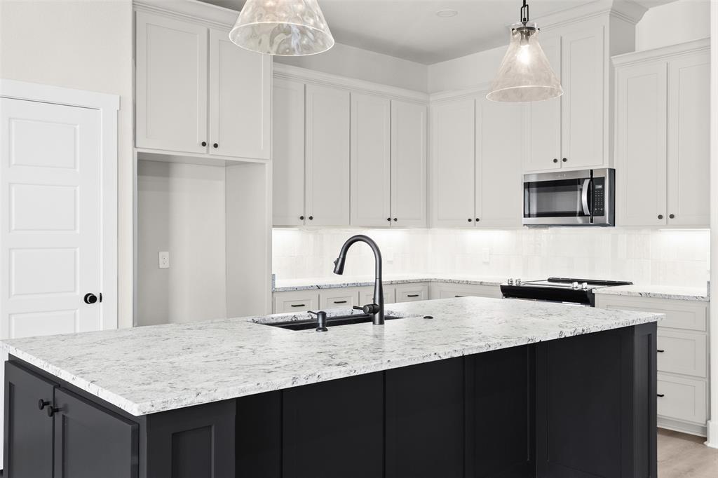 825 Forward Pass Drive Hewitt, TX 76643 - Photo 21 of 37 a kitchen with granite countertop white cabinets and a sink