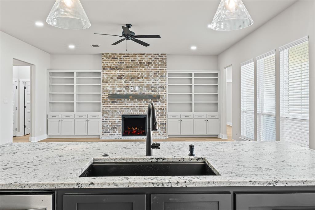 825 Forward Pass Drive Hewitt, TX 76643 - Photo 24 of 37 a kitchen with kitchen island a sink stainless steel appliances and windows