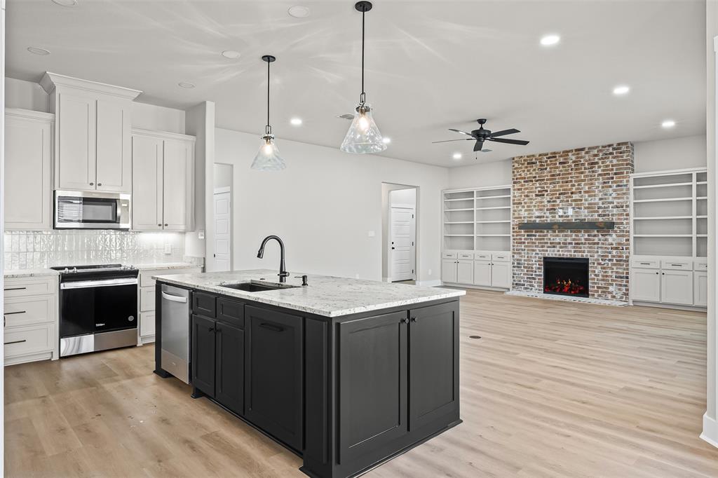 825 Forward Pass Drive Hewitt, TX 76643 - Photo 25 of 37 a kitchen with a sink and a stove top oven