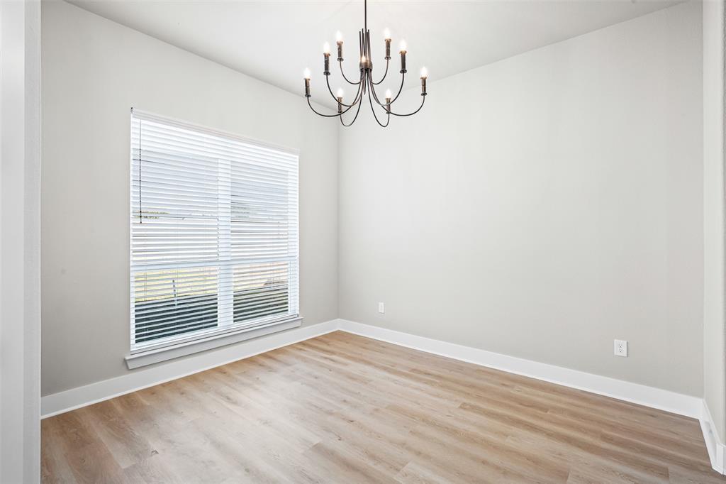 825 Forward Pass Drive Hewitt, TX 76643 - Photo 26 of 37 a view of an empty room with wooden floor and a window