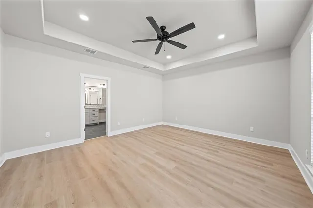 an empty room with closet and windows