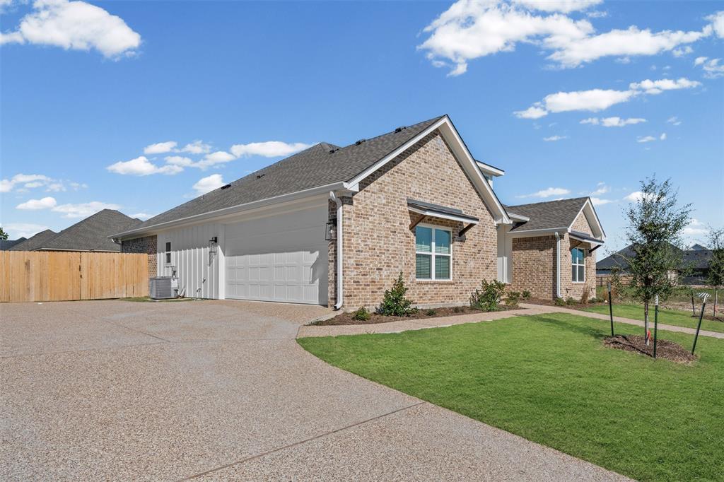 825 Forward Pass Drive Hewitt, TX 76643 - Photo 3 of 37 a front view of a house with a yard and garage