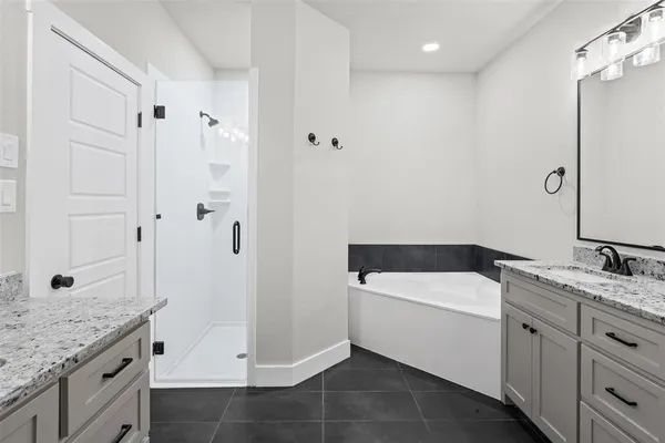 a bathroom with a granite countertop sink a toilet and shower