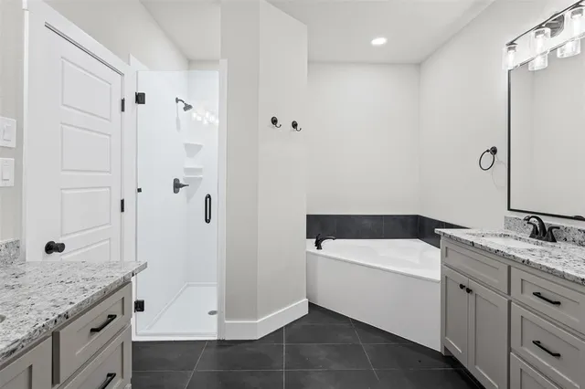 a bathroom with a granite countertop sink a toilet and shower