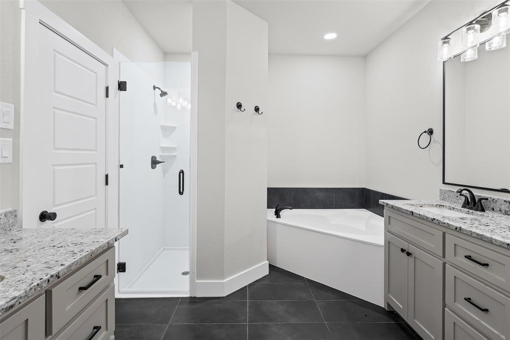 825 Forward Pass Drive Hewitt, TX 76643 - Photo 31 of 37 a bathroom with a granite countertop sink a toilet and shower