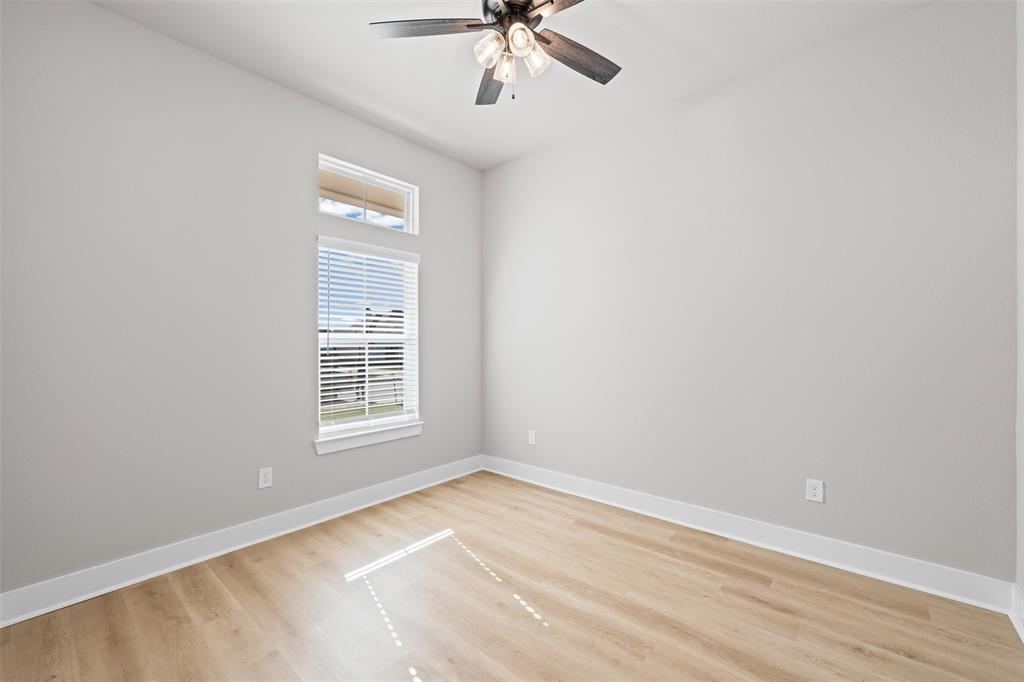 825 Forward Pass Drive Hewitt, TX 76643 - Photo 10 of 37 an empty room with a window and a ceiling fan