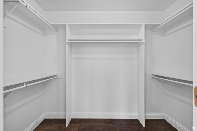 2223 North Pointe Meadow Loop Lehi, UT 84048 - Photo 26 of 56 Expansive walk-in closet featuring white built-in shelving, hanging rods, and wood-finish flooring