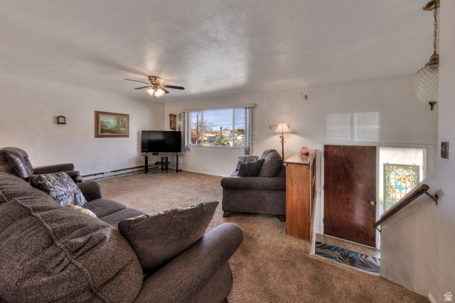 738 Locust Lane Moab, UT 84532 - Photo 4 of 25 Living area featuring carpet flooring, ceiling fan, and baseboard heating