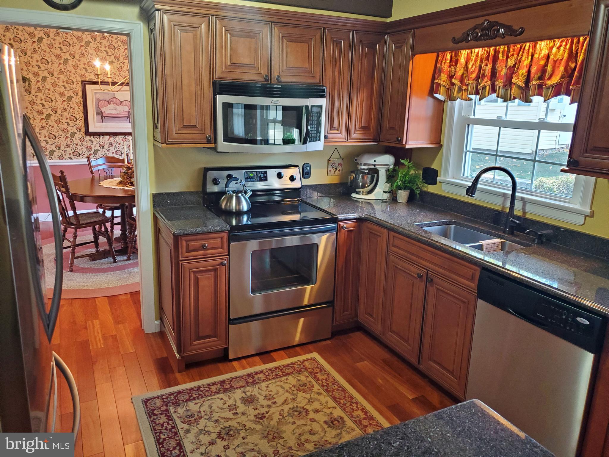 16 Robert Road New Castle, DE 19720 - Photo 11 of 30 a kitchen with stainless steel appliances granite countertop a stove a sink and a microwave
