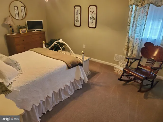 a bedroom with a bed a desk and chair