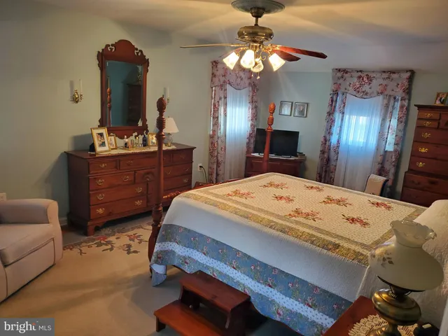 a bed room with a bed mirror and furniture