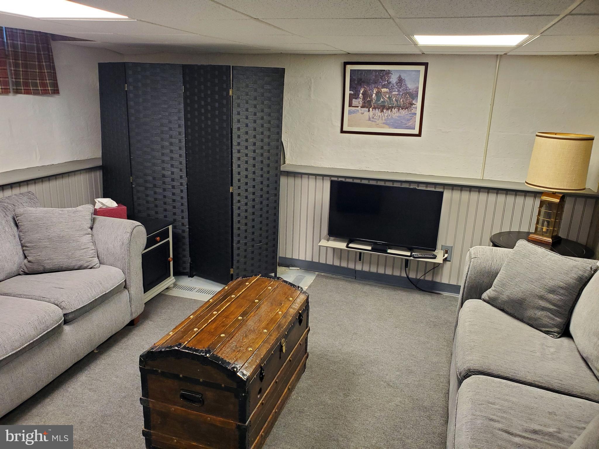16 Robert Road New Castle, DE 19720 - Photo 26 of 30 a living room with furniture and a flat screen tv