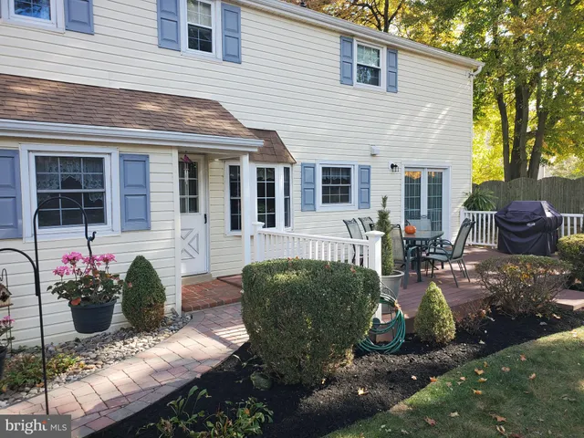 a view of a house with a yard and sitting area