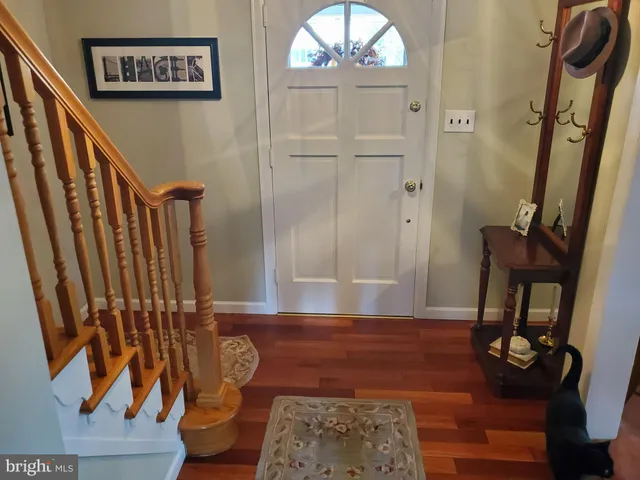 a view of an entryway with wooden floor