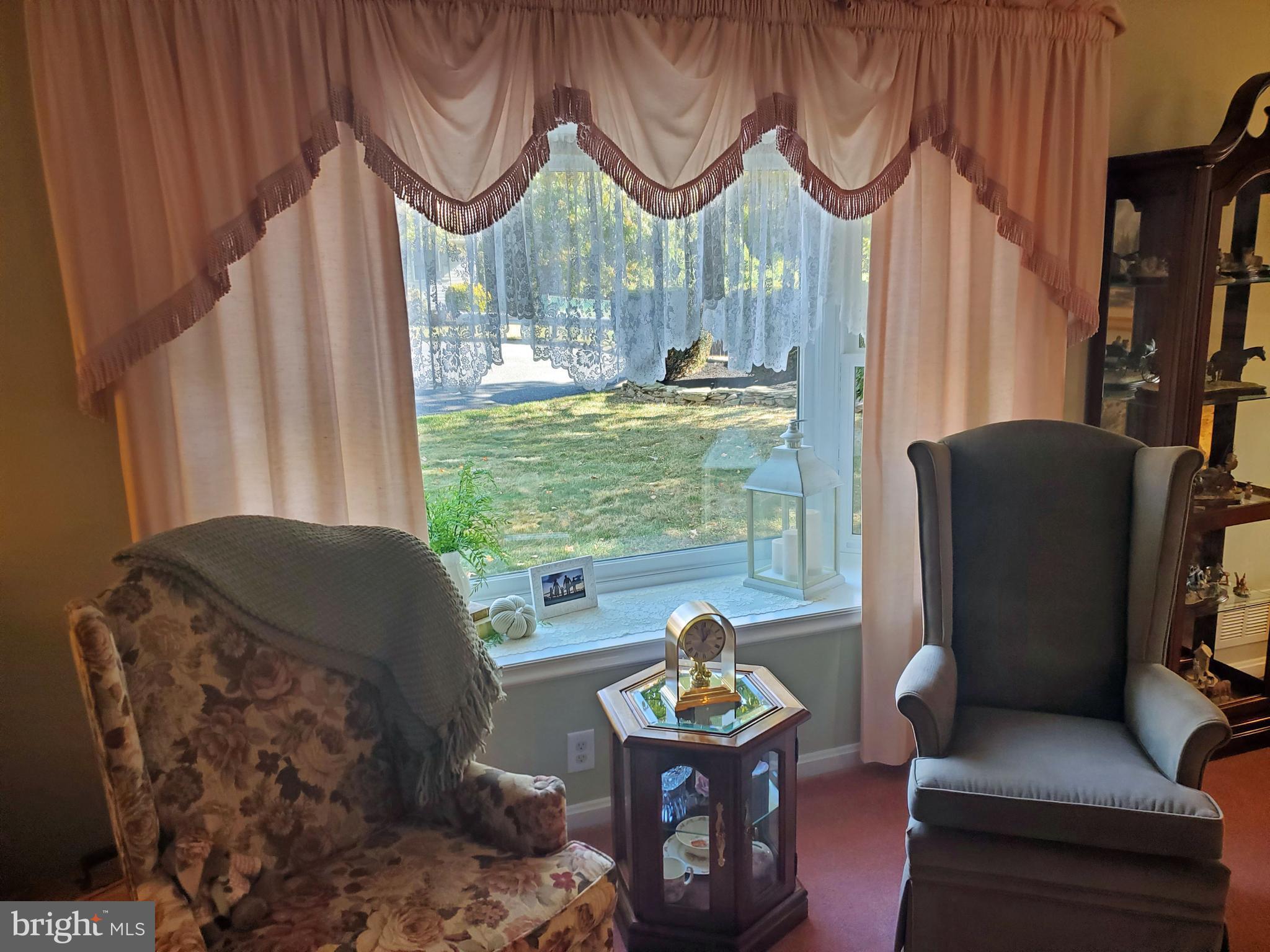 16 Robert Road New Castle, DE 19720 - Photo 9 of 30 a living room filled with furniture and a floor to ceiling window