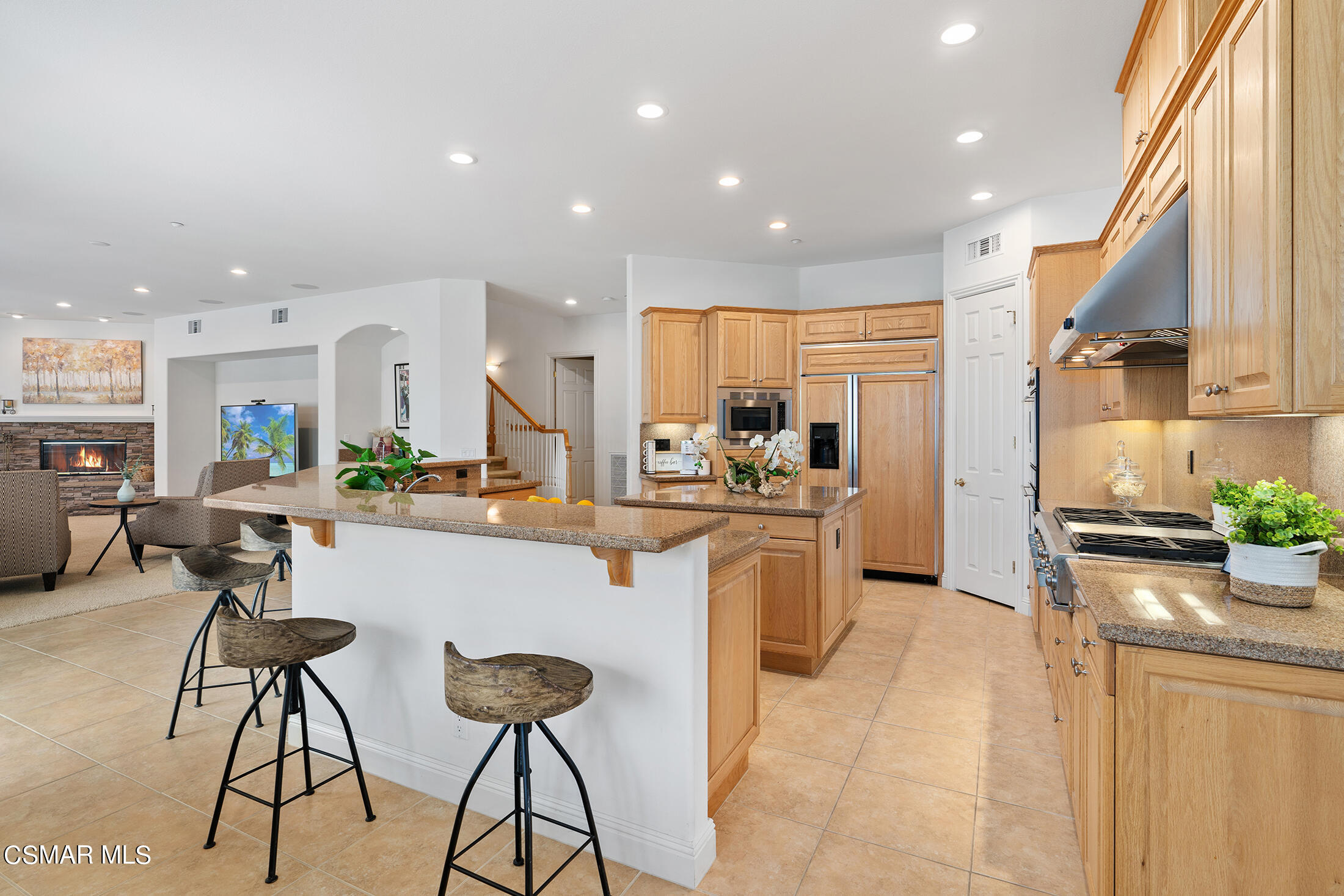 11225 Watson Drive Moorpark, CA 93021 - Photo 27 of 89 a kitchen with stainless steel appliances kitchen island granite countertop a refrigerator and a stove top oven