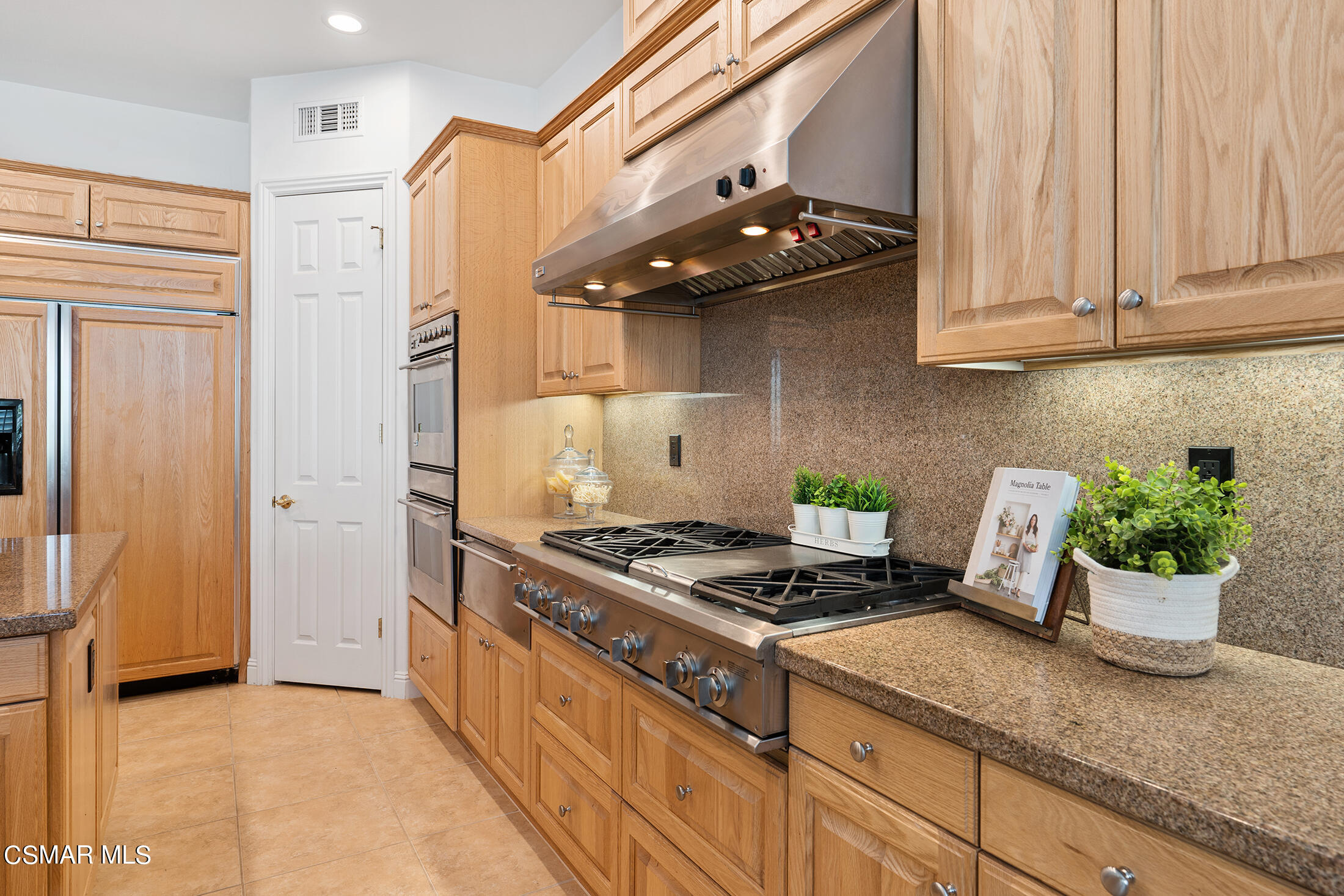 11225 Watson Drive Moorpark, CA 93021 - Photo 28 of 89 a kitchen with stainless steel appliances granite countertop a stove a sink and a refrigerator