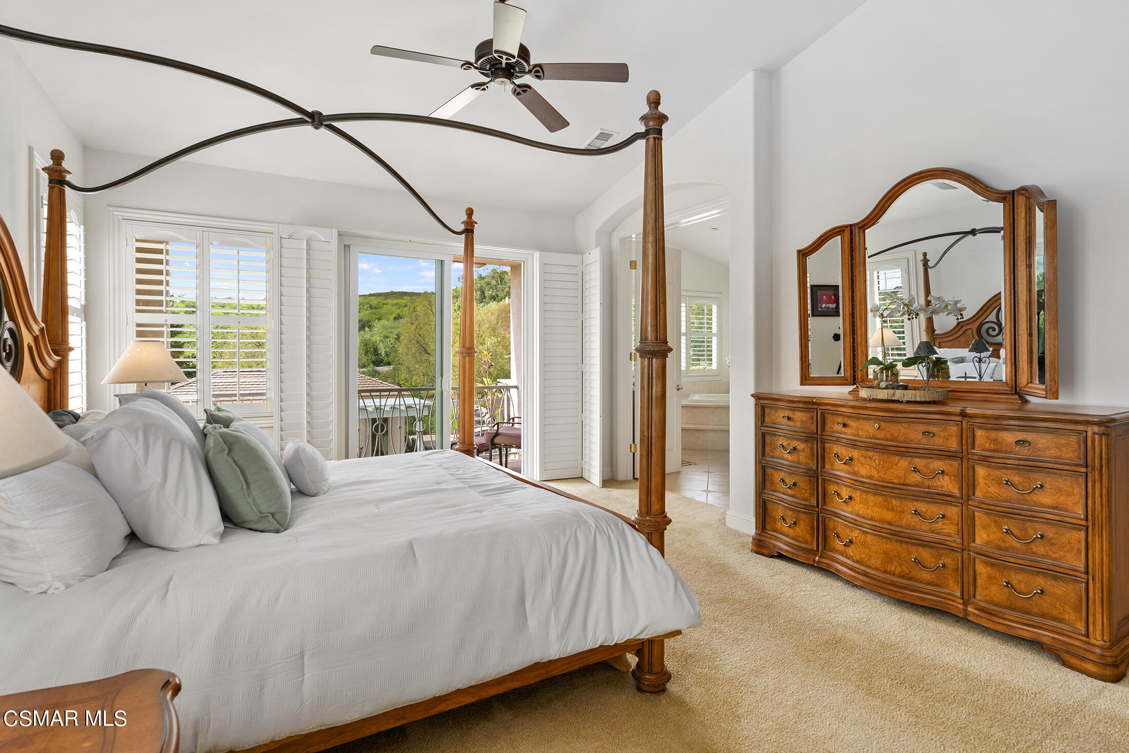 11225 Watson Drive Moorpark, CA 93021 - Photo 54 of 89 a bedroom with a bed a dresser next to a large window with the garden view