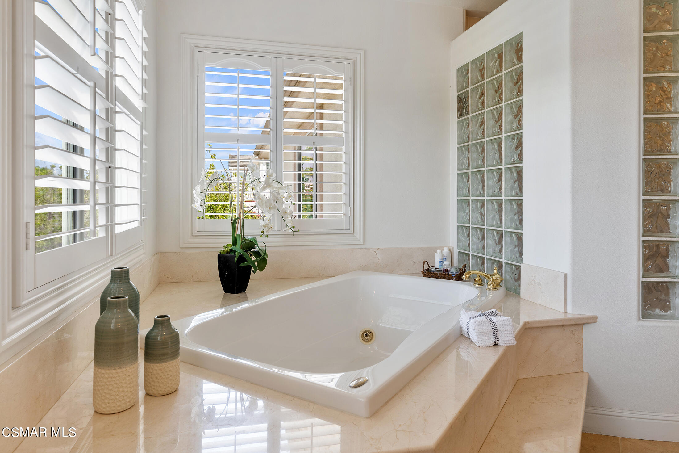 11225 Watson Drive Moorpark, CA 93021 - Photo 57 of 89 a bath tub sitting in front of a window and a chandelier