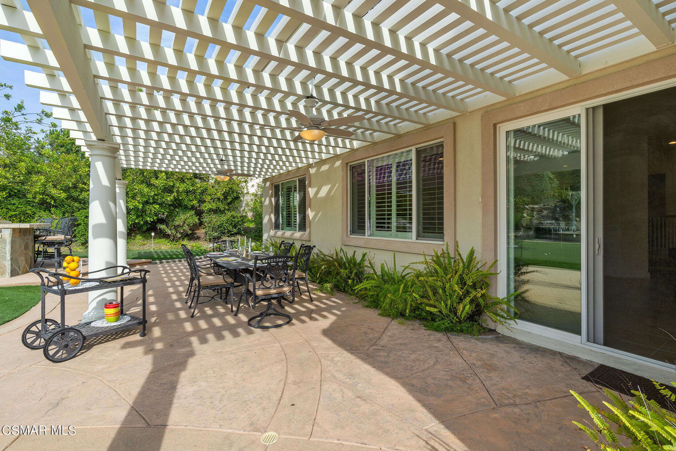 11225 Watson Drive Moorpark, CA 93021 - Photo 64 of 89 a view of a patio with table and chairs potted plants and floor to ceiling window