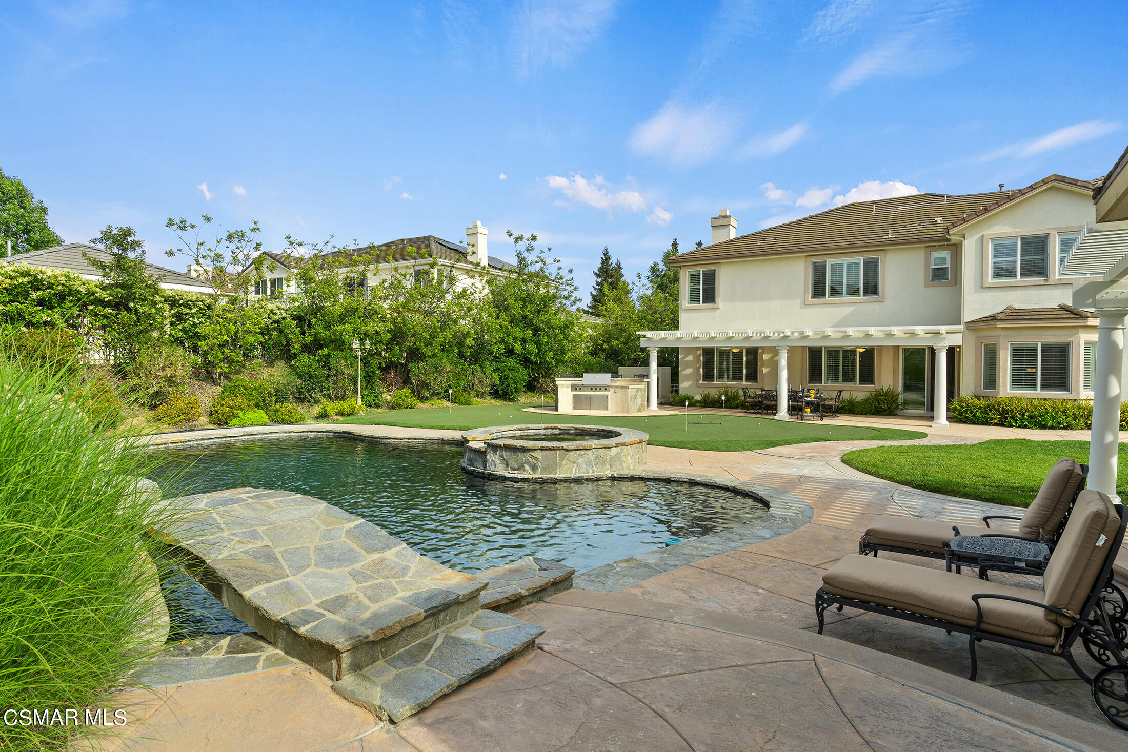 11225 Watson Drive Moorpark, CA 93021 - Photo 69 of 89 a view of a swimming pool and lounge chairs in back yard of the house